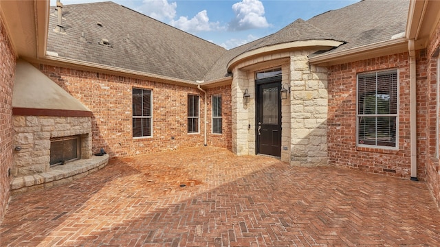 view of patio / terrace with an outdoor stone fireplace