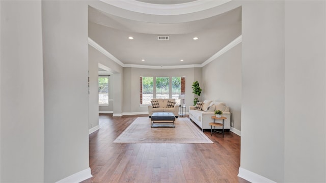 living room featuring wood-type flooring and ornamental molding