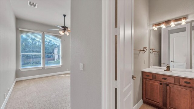 bathroom with ceiling fan and vanity