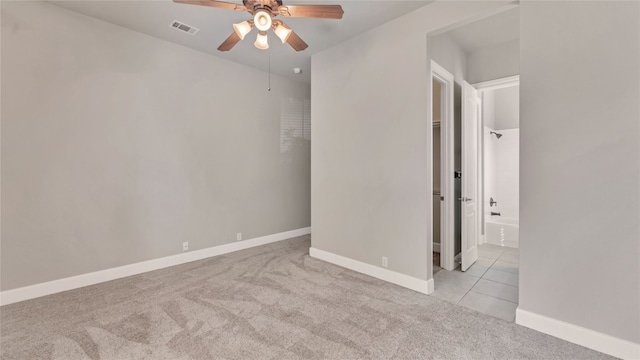 carpeted spare room with ceiling fan