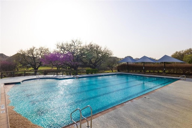 view of pool at dusk