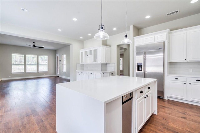 175 Blazing Star Dr, Austin, TX 78737 - kitchen with built in refrigerator, a center island, white cabinetry, light countertops, and recessed lighting