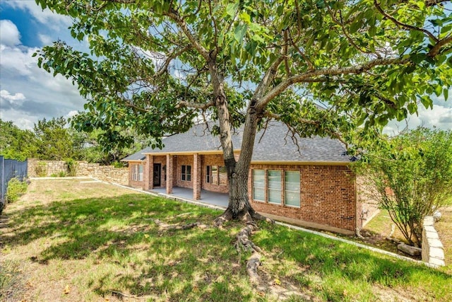 175 Blazing Star Dr, Austin, TX 78737 - back of property with brick siding, a patio, and roof with shingles