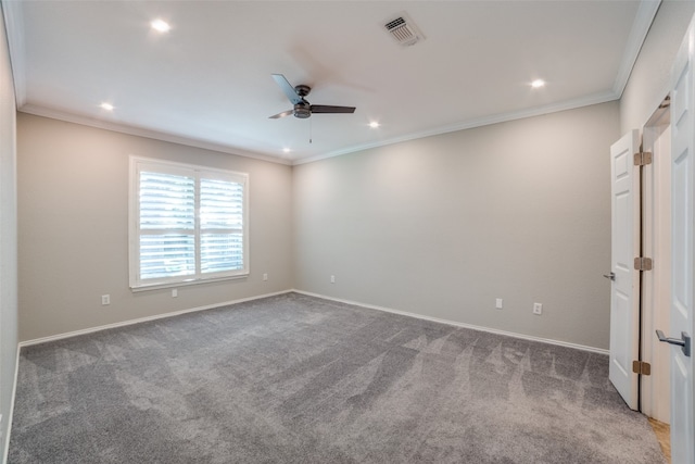 carpeted spare room with ceiling fan and crown molding