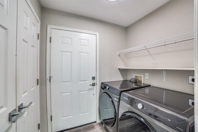 laundry room featuring hardwood / wood-style flooring and independent washer and dryer