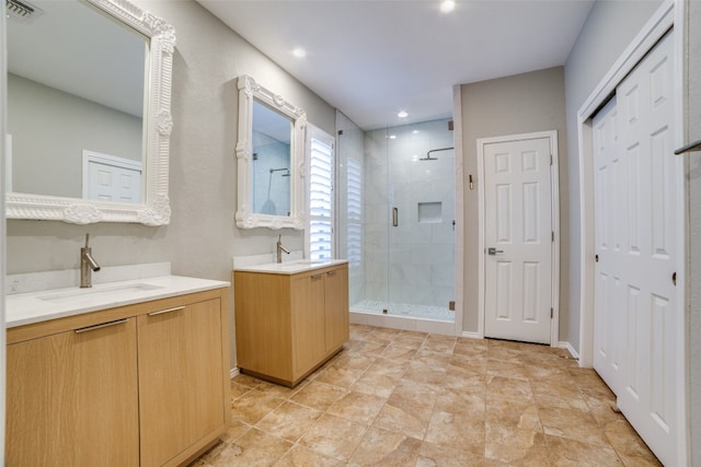 bathroom featuring vanity and a shower with shower door