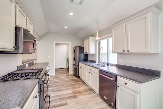 kitchen featuring light hardwood / wood-style flooring, stainless steel appliances, lofted ceiling, and white cabinetry