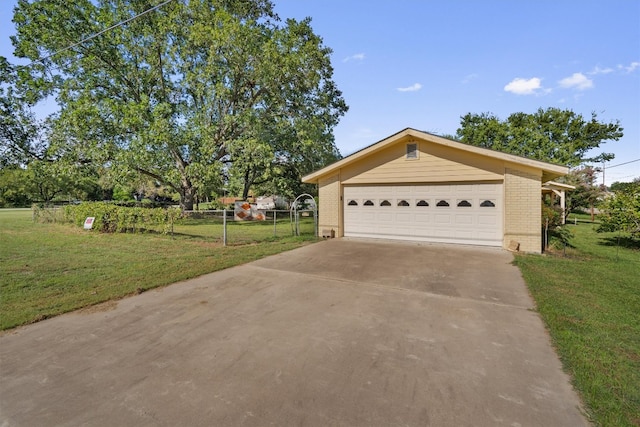 view of front facade with a garage, a front lawn, and an outbuilding