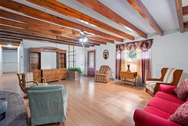 living room featuring beam ceiling, ceiling fan, and light hardwood / wood-style floors