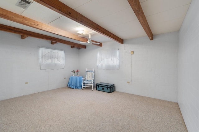 empty room with carpet floors, beamed ceiling, and brick wall