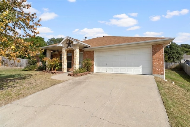 ranch-style house featuring a front lawn and a garage