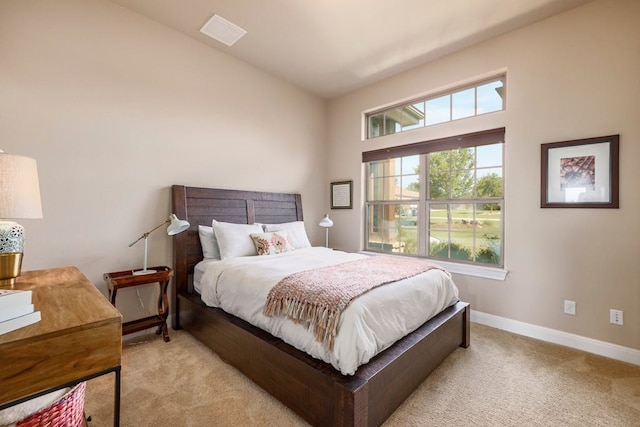 bedroom featuring vaulted ceiling and light carpet