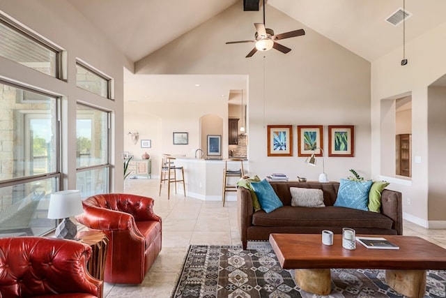 living room with ceiling fan, light tile patterned floors, and high vaulted ceiling