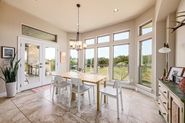 dining room with a healthy amount of sunlight, french doors, and a notable chandelier