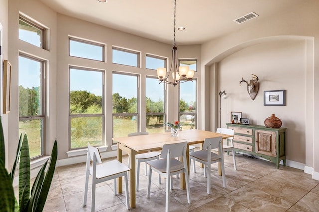 dining space with plenty of natural light and a chandelier