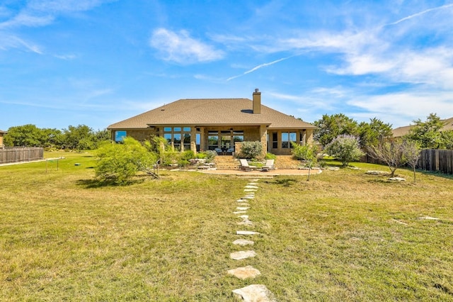 back of property featuring a lawn