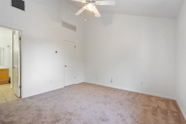 unfurnished room with light colored carpet, high vaulted ceiling, and ceiling fan