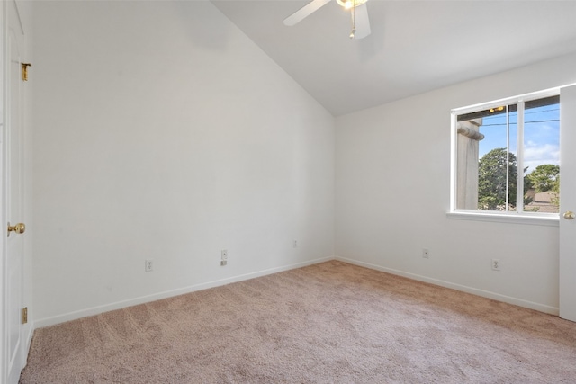 unfurnished room with ceiling fan, light carpet, and vaulted ceiling