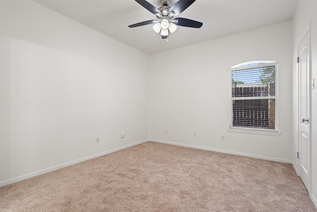 carpeted spare room with ceiling fan