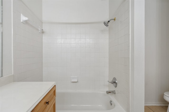 full bathroom featuring tile patterned floors, vanity, toilet, and tiled shower / bath