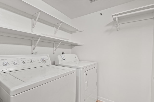 clothes washing area featuring separate washer and dryer