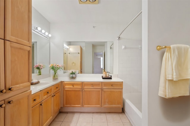 bathroom with tile patterned flooring, vanity, and tiled shower / bath combo