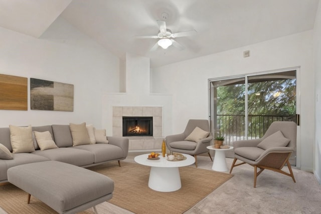 living room with light carpet, vaulted ceiling, ceiling fan, and a fireplace