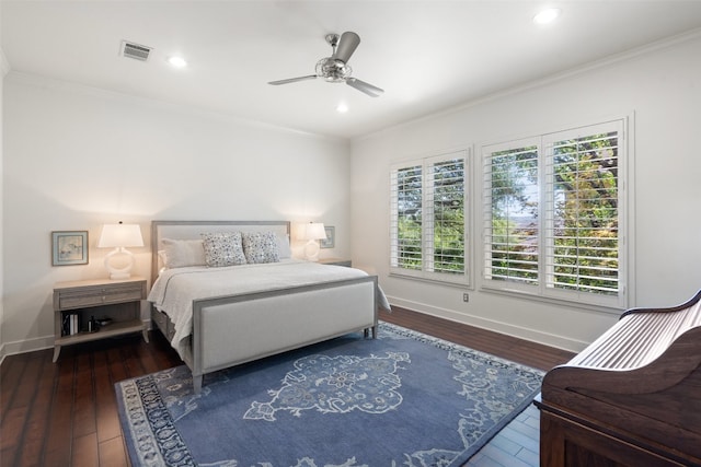 bedroom with ceiling fan, ornamental molding, and dark hardwood / wood-style flooring