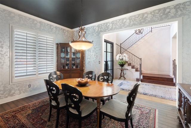 dining area with crown molding, hardwood / wood-style floors, and a wealth of natural light