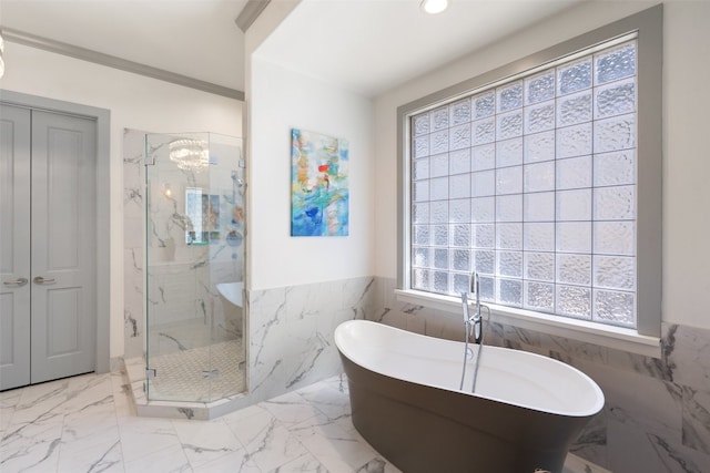 bathroom with tile walls, crown molding, and shower with separate bathtub