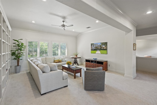 carpeted living room featuring ornamental molding and ceiling fan