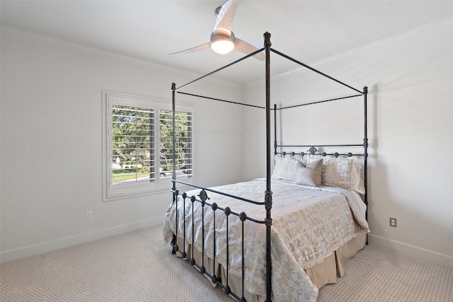 bedroom featuring ornamental molding, ceiling fan, and light colored carpet