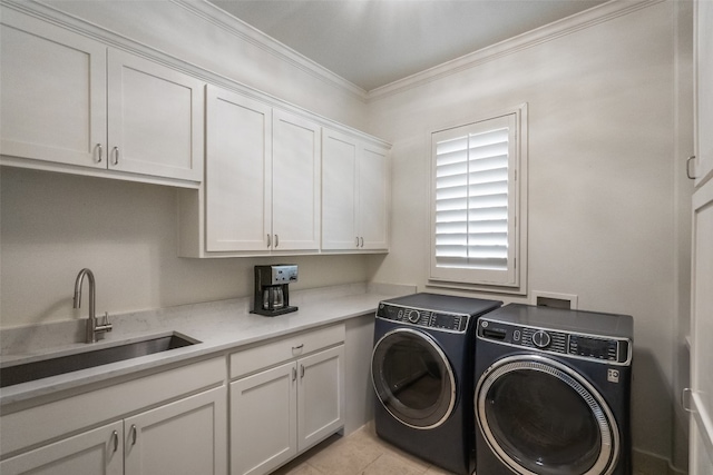 laundry area with light tile patterned flooring, cabinets, ornamental molding, sink, and washer and dryer