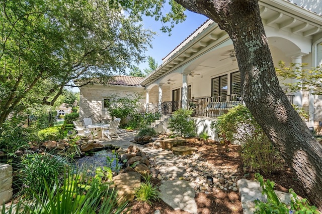 view of yard with ceiling fan and a patio area