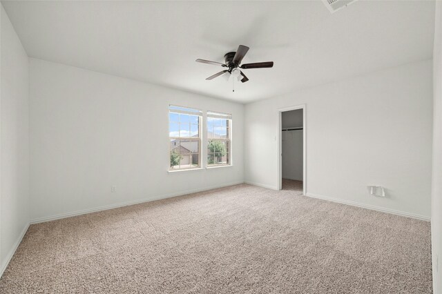 unfurnished bedroom featuring carpet, ceiling fan, and a closet