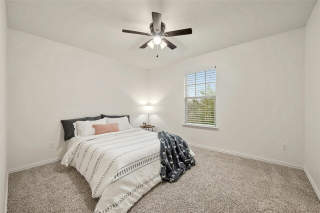 bedroom with light carpet and ceiling fan