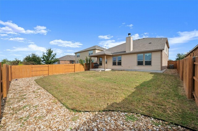 back of property featuring a lawn and a patio