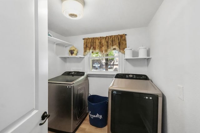 laundry room featuring light wood-style floors, laundry area, and separate washer and dryer