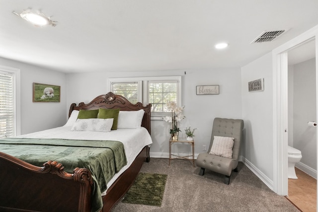 bedroom with carpet flooring and connected bathroom