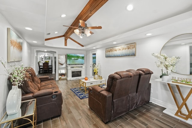 living room with wood-type flooring, lofted ceiling with beams, and ceiling fan