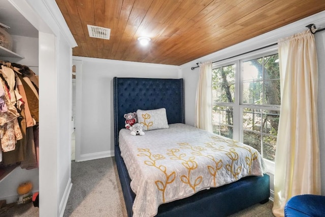 carpeted bedroom featuring wooden ceiling, baseboards, and visible vents