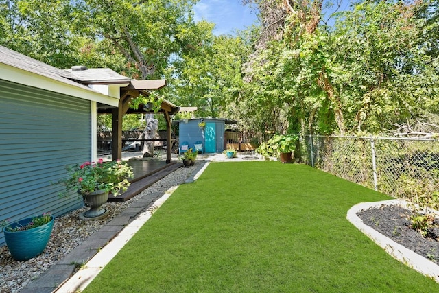 view of yard featuring a fenced backyard, an outdoor structure, and a shed