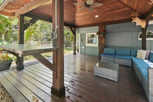 wooden terrace featuring outdoor lounge area and ceiling fan