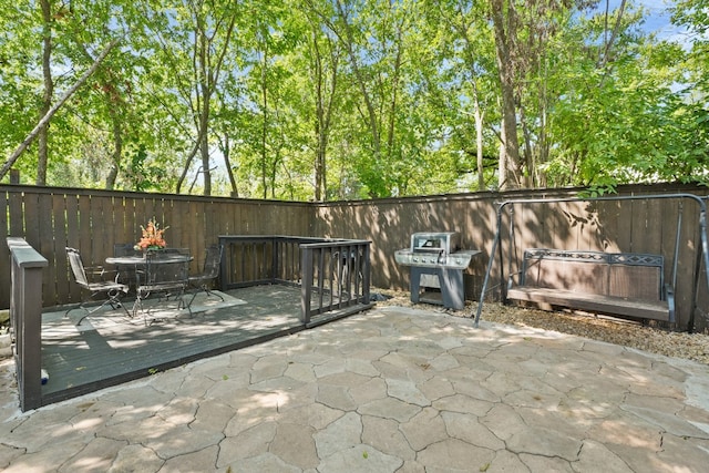 view of patio featuring area for grilling and a deck