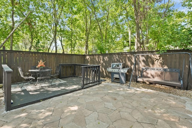 view of patio with fence and a wooden deck