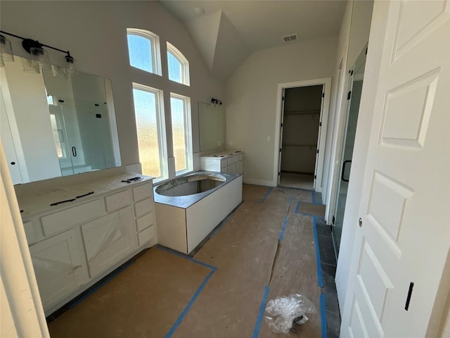 bathroom with vanity, lofted ceiling, separate shower and tub, and a healthy amount of sunlight