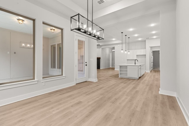 interior space with sink and light hardwood / wood-style flooring