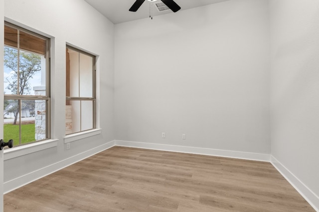 empty room with ceiling fan and light wood-type flooring