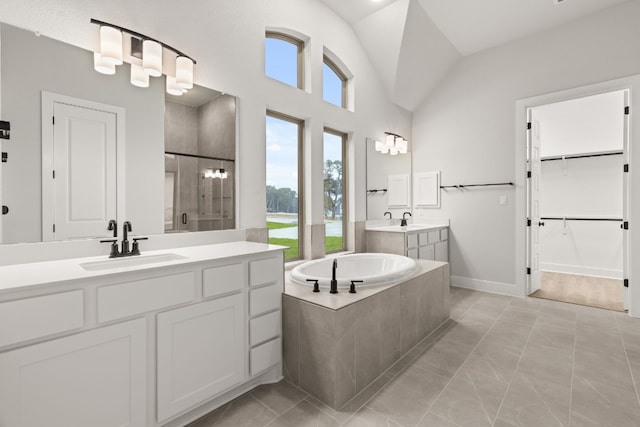 bathroom with tile patterned flooring, plus walk in shower, and vanity