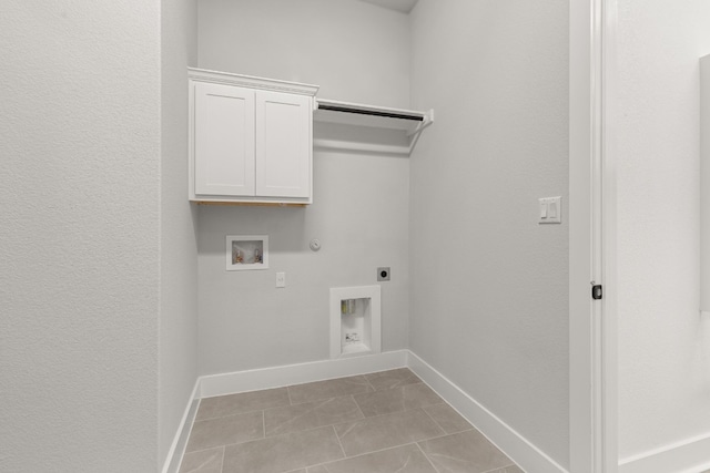 laundry room featuring hookup for a gas dryer, cabinets, washer hookup, light tile patterned floors, and hookup for an electric dryer